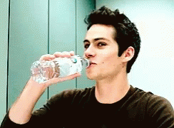 Dylan O'Brien spitting out water laughing gif