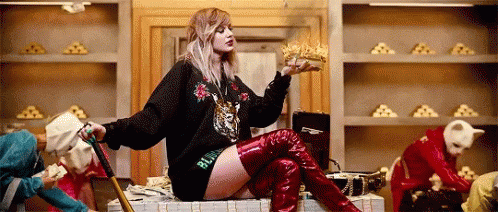 Taylor Swift surrounded by money flying around.