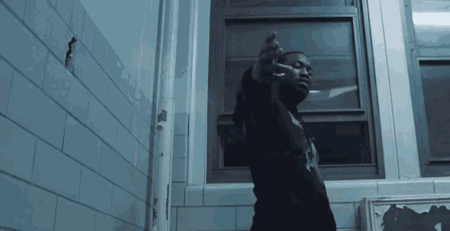 pointing gun at head listening to music gif