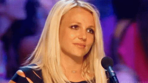 Britney Spears grimacing while listening to a contestant on a popular singing competition show.