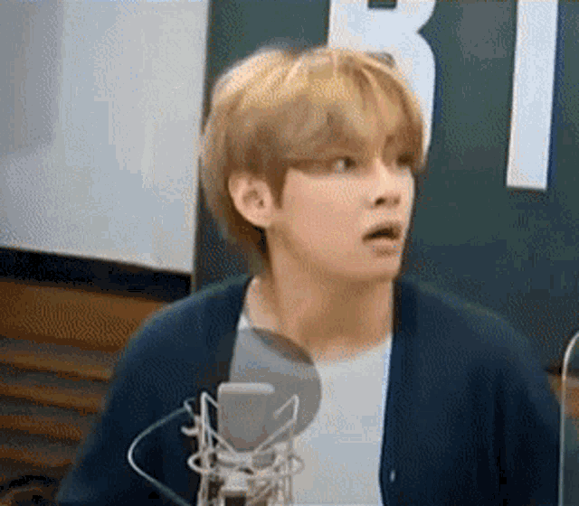 BTS V looking shocked in a radio show booth