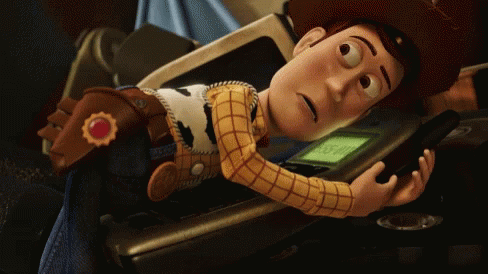 A GIF from Toy Story 3. Woody, the toy cowboy, is holding a phone and looking very anxious.