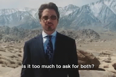 A dark haired, goateed man in shades, suit, and tie (Tony Stark) stands in a desert and asks, "Is it too much to ask for both?"