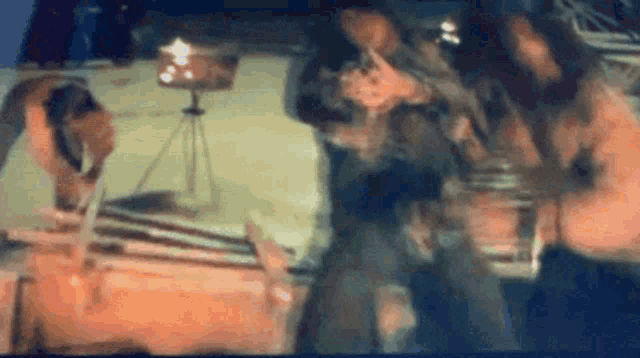 a blurry picture of a man standing in front of a tripod .