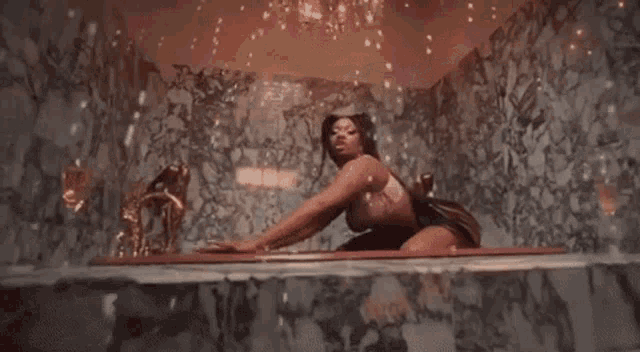 a woman is kneeling in a bathtub with her legs crossed .