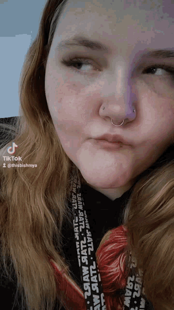 a close up of a woman 's face with a tiktok watermark on the bottom right