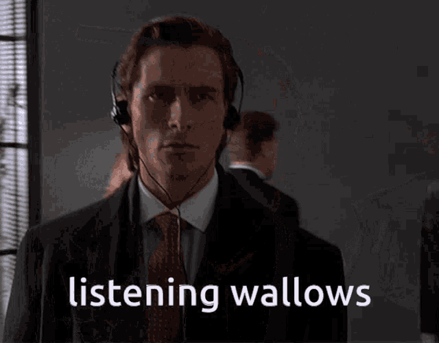 a man wearing headphones with the words listening wallows on the bottom