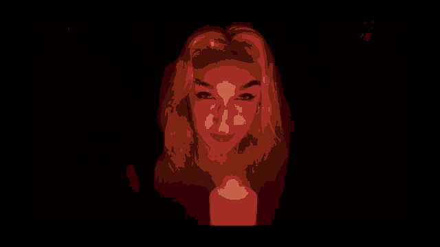 a woman stands in front of a lit candle with her tongue out