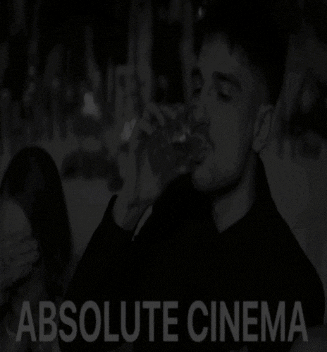 a black and white photo of a man drinking from a glass with the words absolute cinema above him