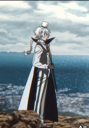 a man in a top hat and cape is standing on a rock