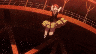 a girl in a black and yellow dress is dancing on a stage .