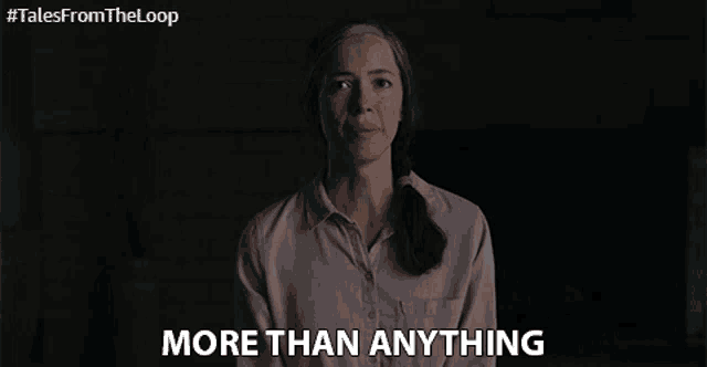a woman in a pink shirt says more than anything in a dark room