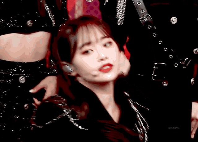 a close up of a woman 's face with a microphone in her ear and the word chuling written below her