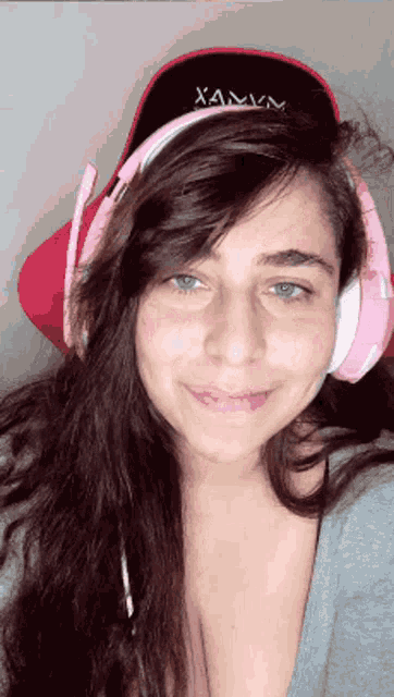 a woman wearing headphones and a hat with xamvm on it