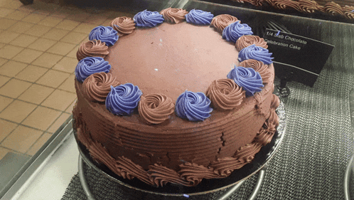 a chocolate cake with purple frosting sits on display