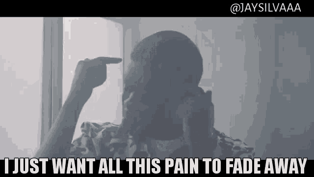 a man pointing at his head with the words " i just want all this pain to fade away " below him