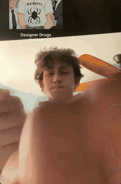 a man wearing a kenzo shirt stands in front of a screen that says designer drugs welland