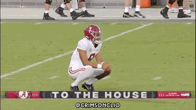 a football player kneeling on the field with the words to the house behind him