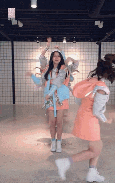 a girl in an orange dress is dancing in a room with a sign that says passion