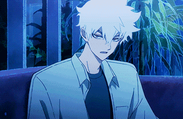 a boy with white hair is sitting on a couch