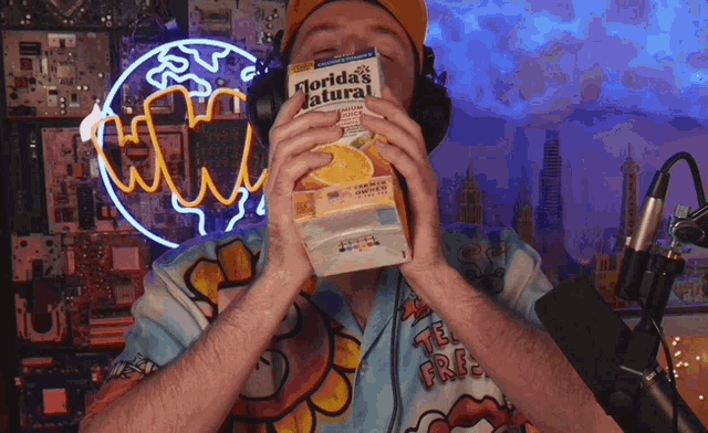 a man holds a box of florida 's natural orange juice