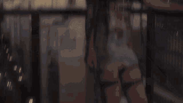 a blurry picture of a woman standing on a balcony with a city in the background