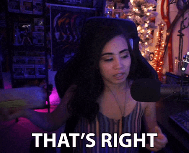 a woman sitting in front of a microphone with the words that 's right below her