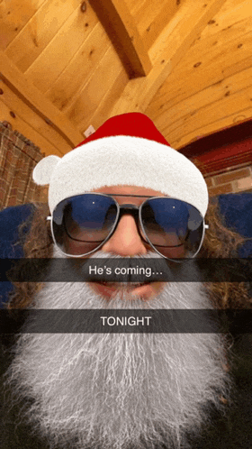 a man wearing a santa hat and sunglasses says he 's coming ... tonight