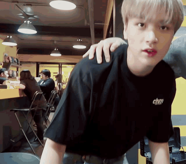 a man wearing a black shirt with chm on the back