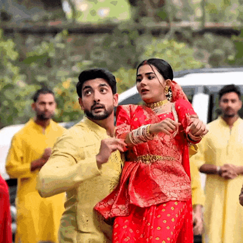 a man and a woman are dancing in front of a crowd .
