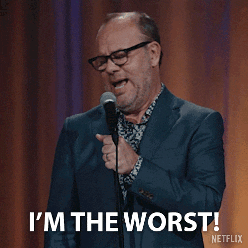 a man holding a microphone says i 'm the worst