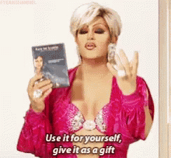 a woman in a pink dress is holding a book and says use it for yourself give it as a gift