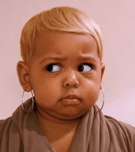 a little girl with hoop earrings on her ears