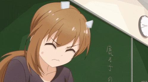 a girl with horns on her head sits in front of a blackboard with chinese writing