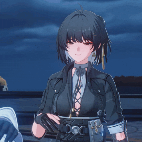 a girl with black hair is wearing a black leather jacket and gloves