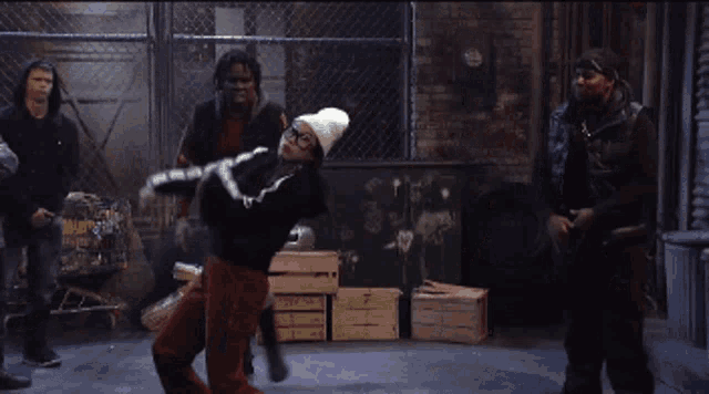 a group of people are dancing in a room with a sign that says n on it