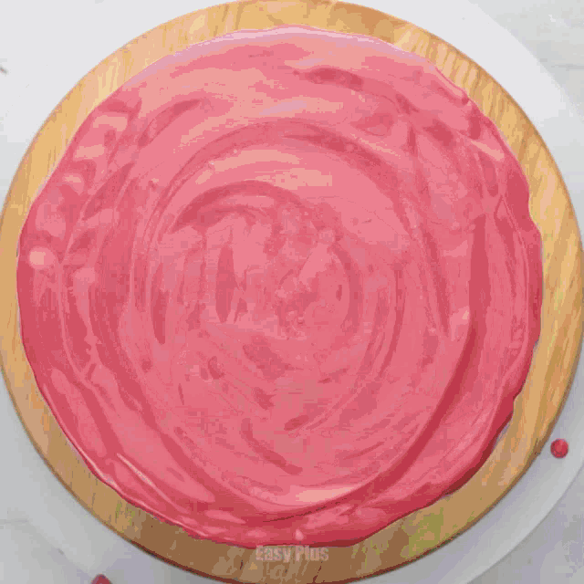 a cake with rainbow frosting is being decorated