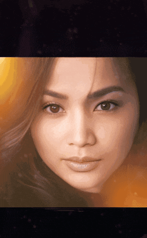 a close up of a woman 's face with brown eyes