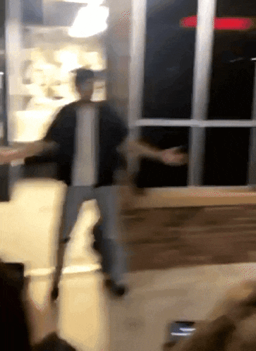 a blurry picture of a man walking in a room