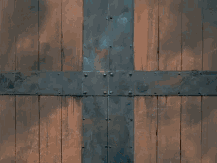 a man in a mask is peeking out of a door