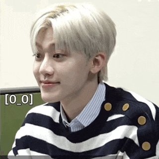 a young man wearing a black and white striped sweater