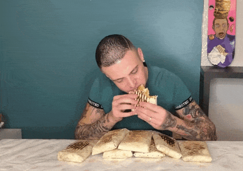 a man eating a taco with a shirt that says connected on the sleeves