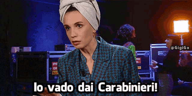 a woman with a towel on her head says " lo vado dai carabinieri "