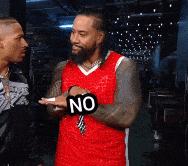 a man wearing a red jersey with the word no written on it