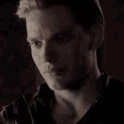 a close up of a man 's face with a serious expression .