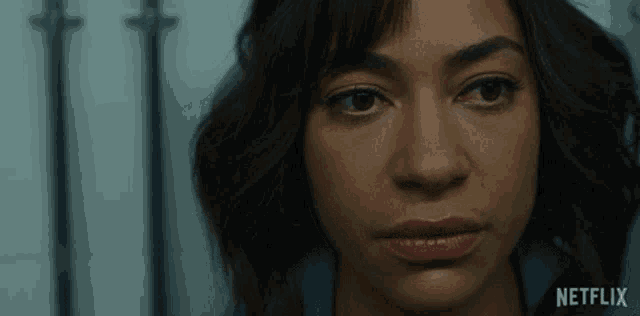 a close up of a woman 's face with the netflix logo visible