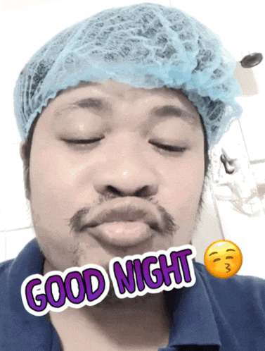 a man wearing a surgical cap and a blue shirt says good night