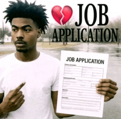 a man is holding a job application with a broken heart on it