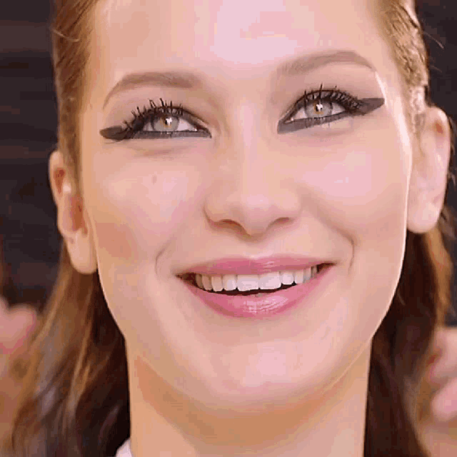 a close up of a woman 's face with her mouth open