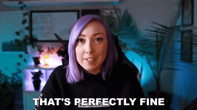 a woman with purple hair says " that 's perfectly fine " in front of a plant